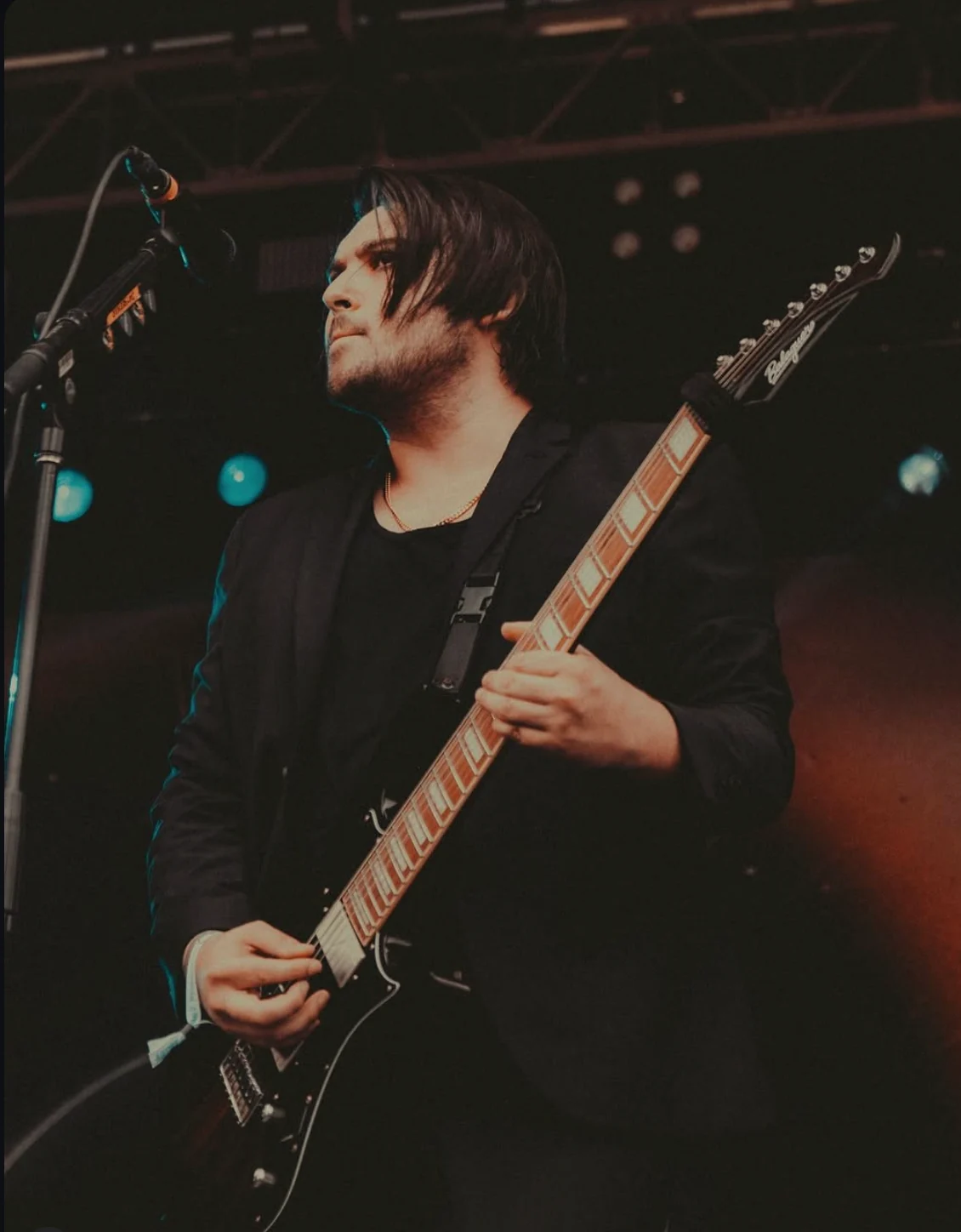 Gino Sgambelluri performing guitar onstage